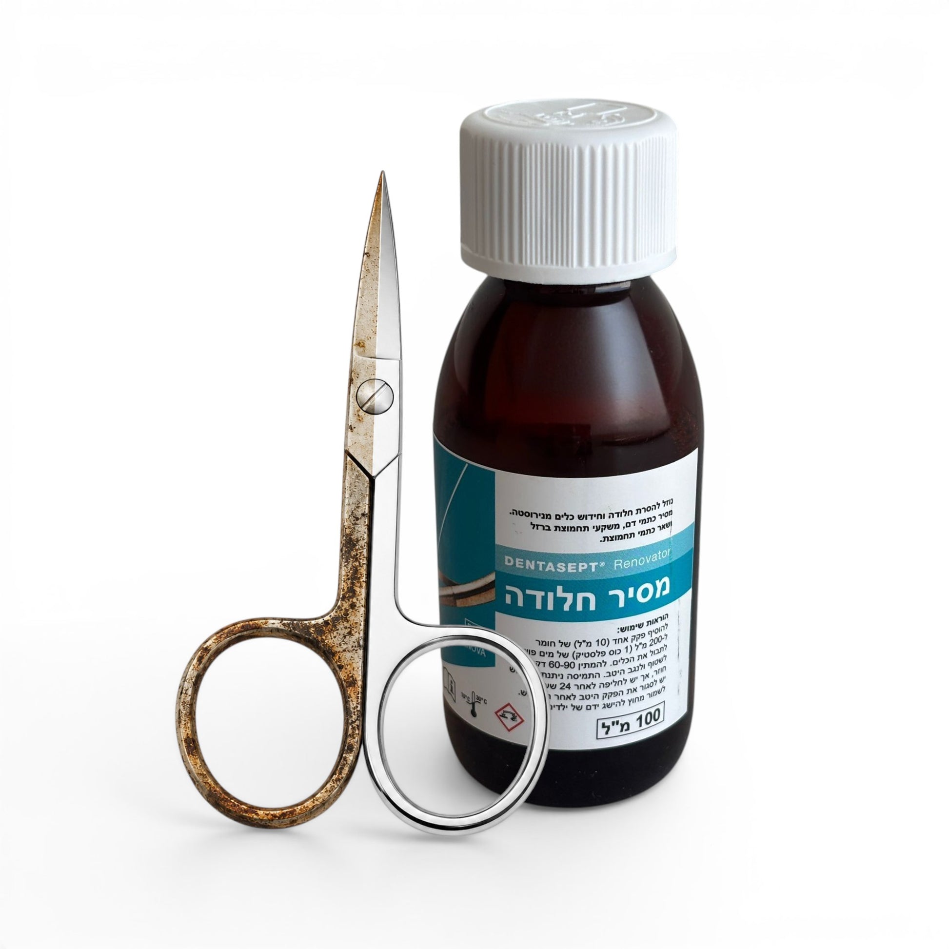 Bottle of DSI Ultrasonic Stainless Steel Renovator with a pair of rusty scissors on a white background