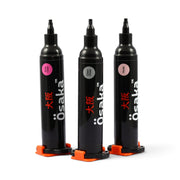 Three black Osaka Builder Gel Injector for Nails, 10ml marker pens with orange stands, displayed on a clean white background. The markers feature pink, gray, and light pink ink caps, with the brand name 'Osaka' printed vertically in white and red.